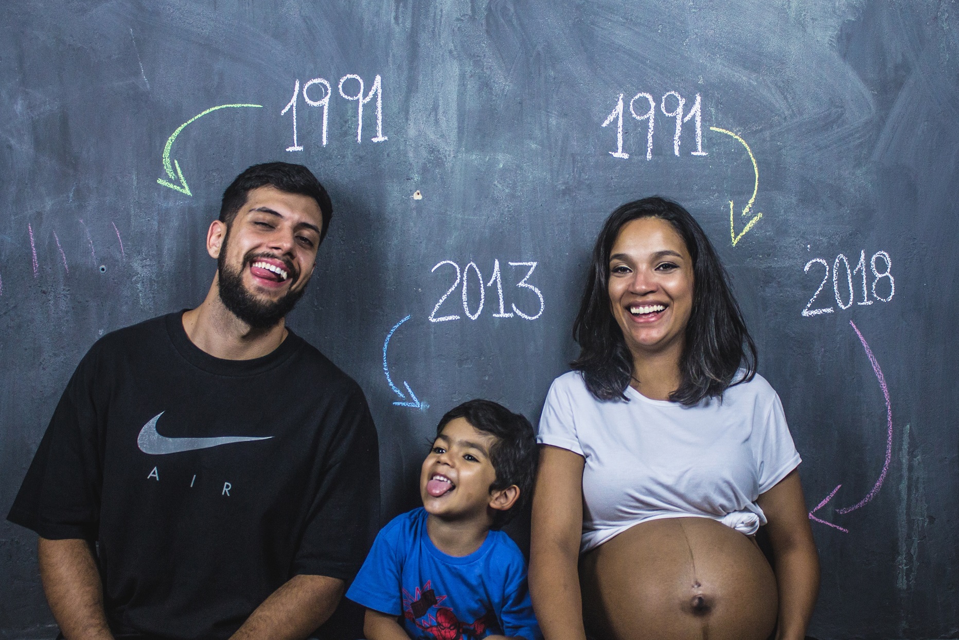 Happy Indian family posing and smiling at camera together