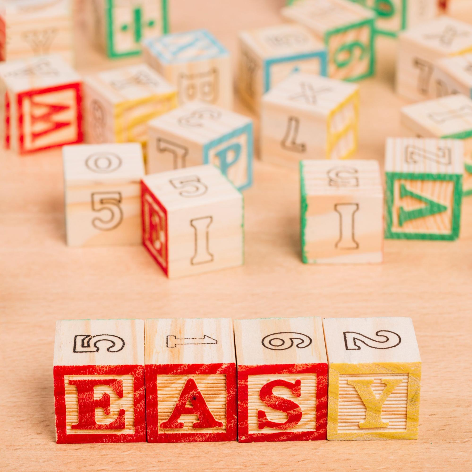 Colorful alphabet blocks spelling 'EASY', a fun baby shower gift idea