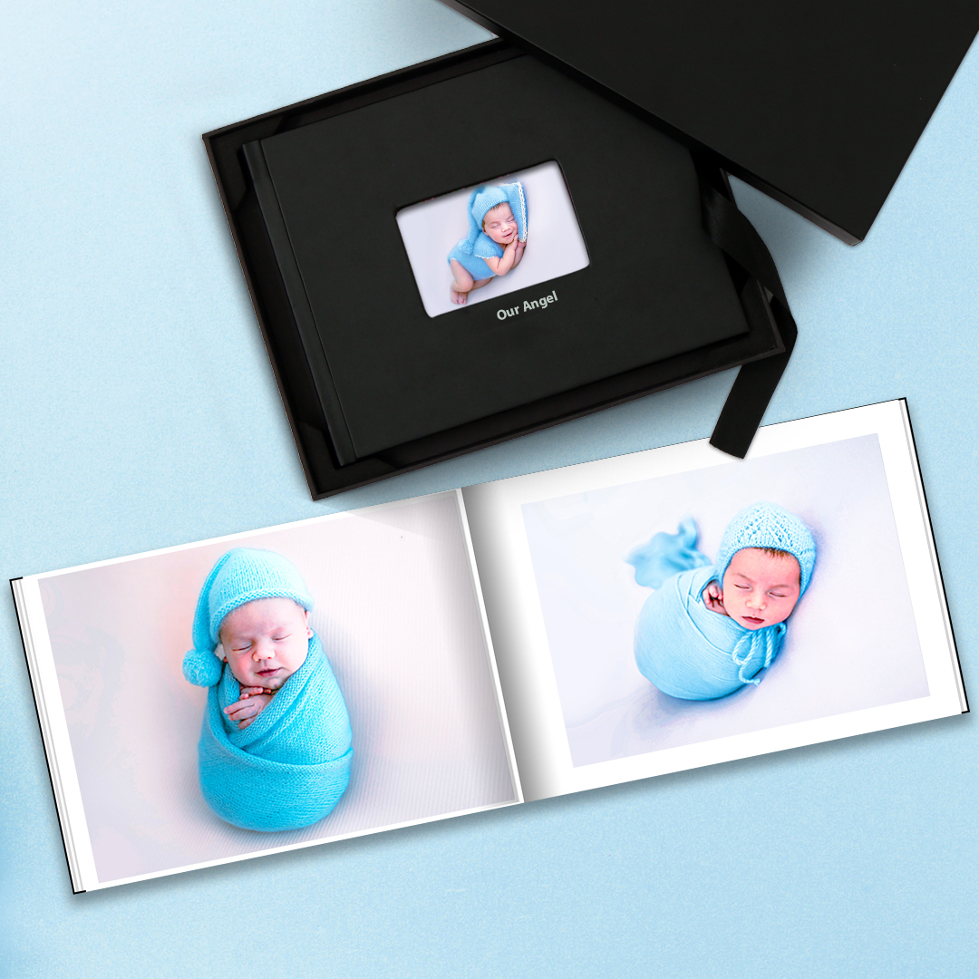Photo album of baby pictures, an excellent baby shower gift idea, on blue