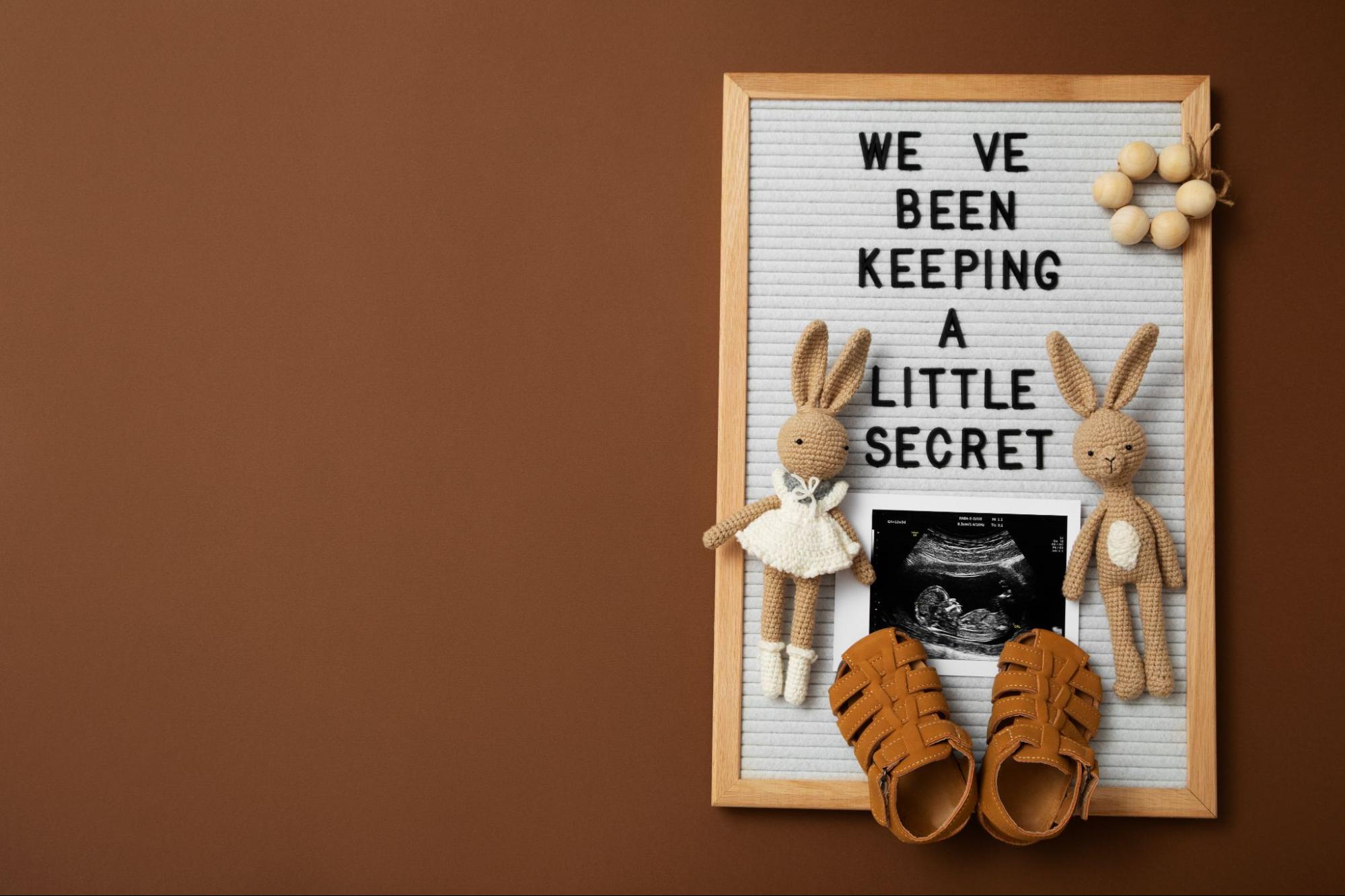 Letterboard with sonogram and baby items, a creative baby shower gift idea
