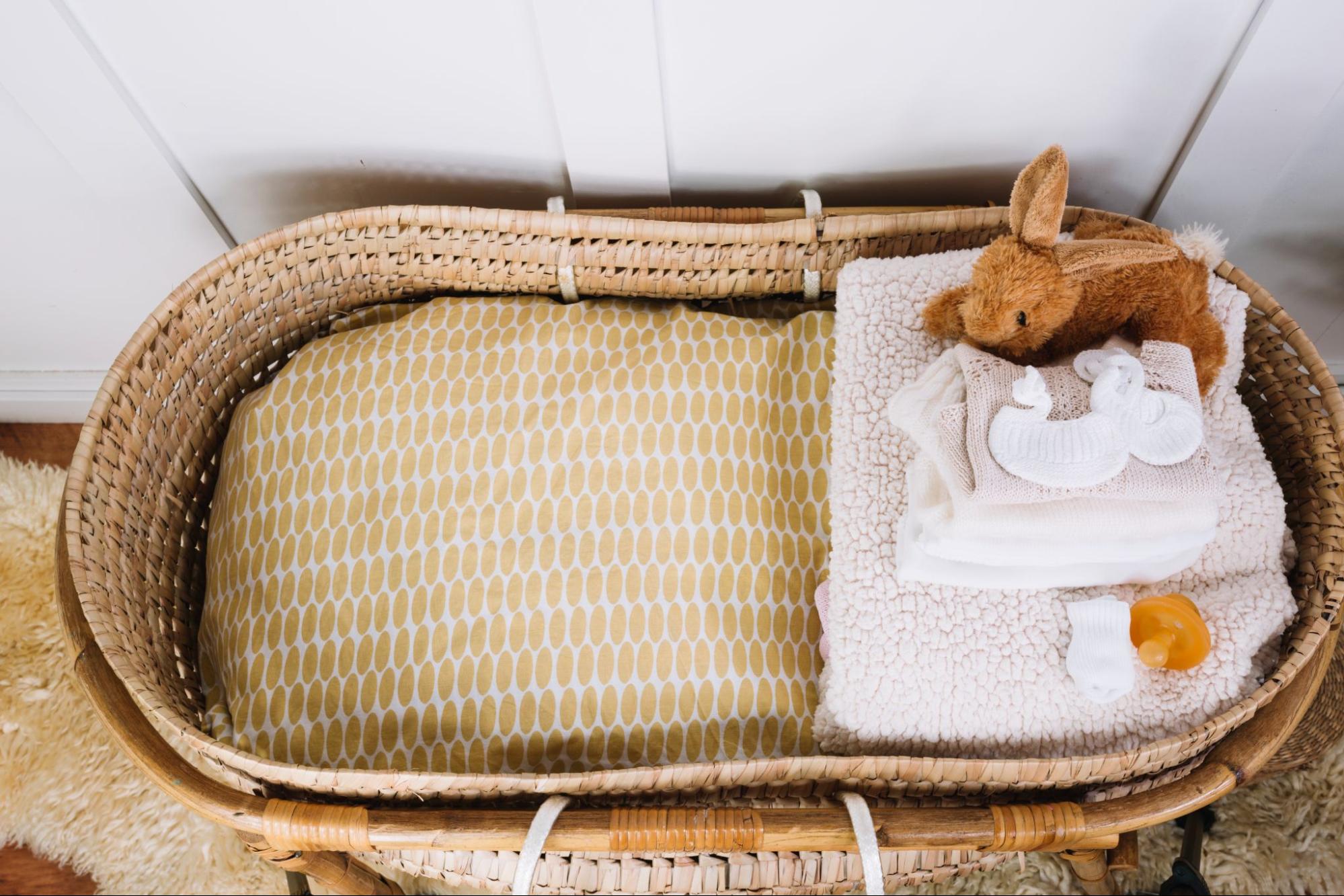 Moses basket with cozy baby essentials, perfect for baby shower gift ideas