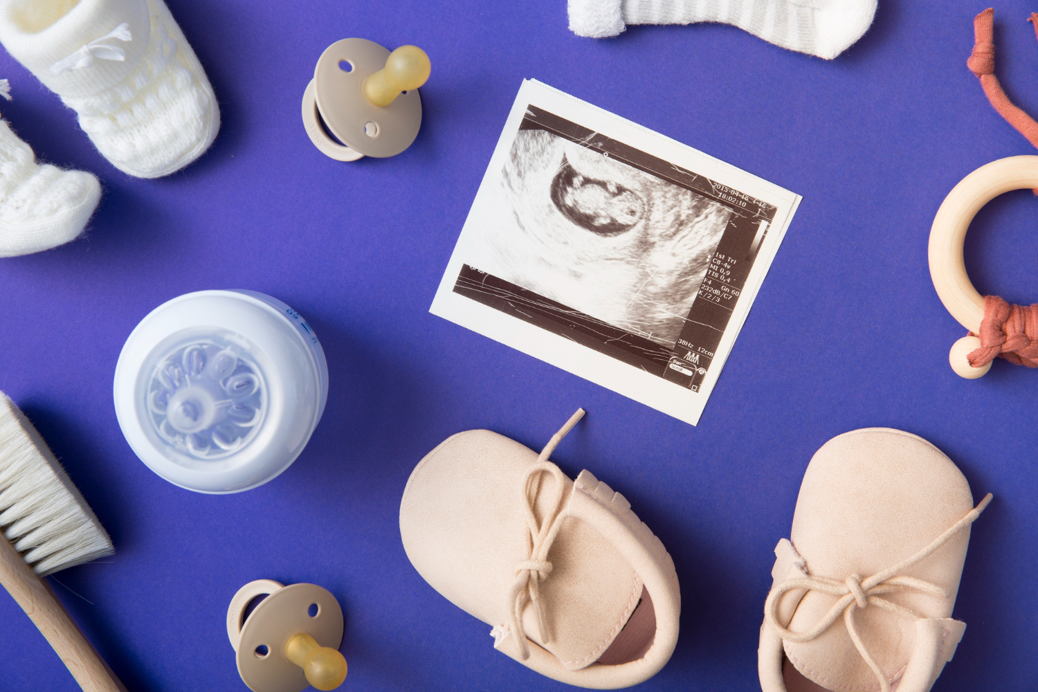 Newborn essentials and ultrasound, perfect baby shower gift ideas, on blue