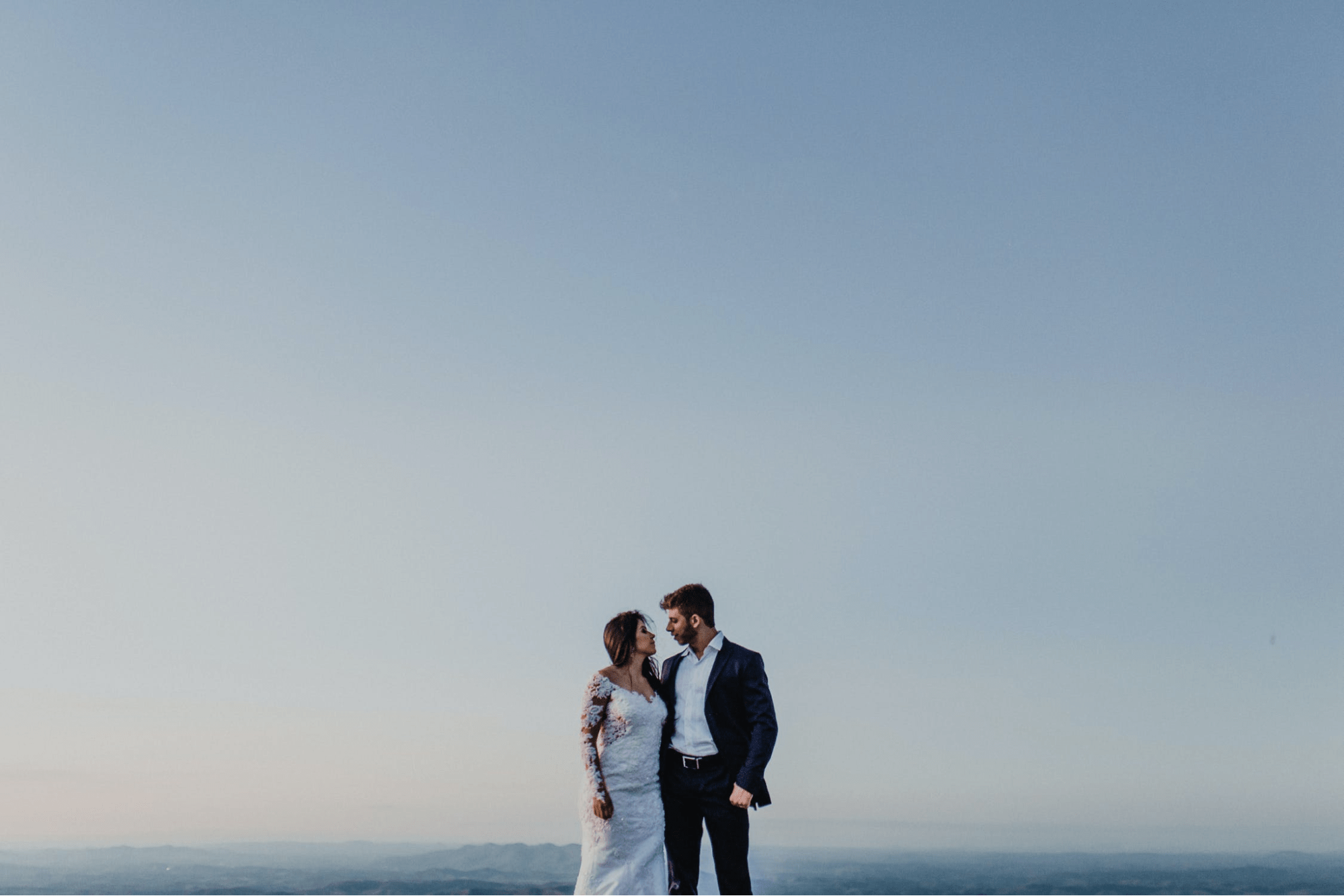 Portrait of affectionate newlyweds touching by their noses. Bride and groom  posing on nature. Wedding Stock Photo by ©stahov 163421522