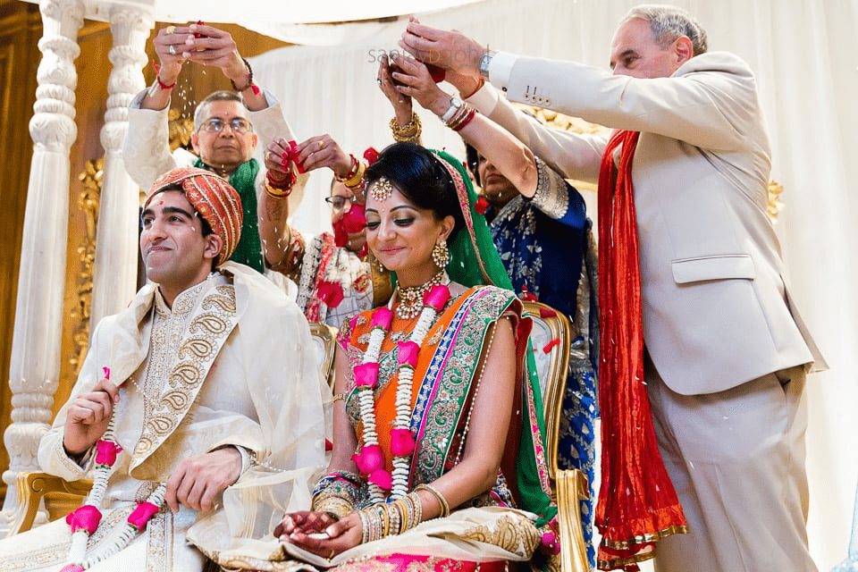  Bride and groom being blessed by their parent's wedding pose 