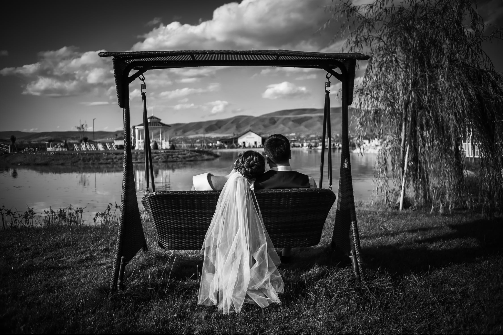 Black and while couple wedding pose on a swing
