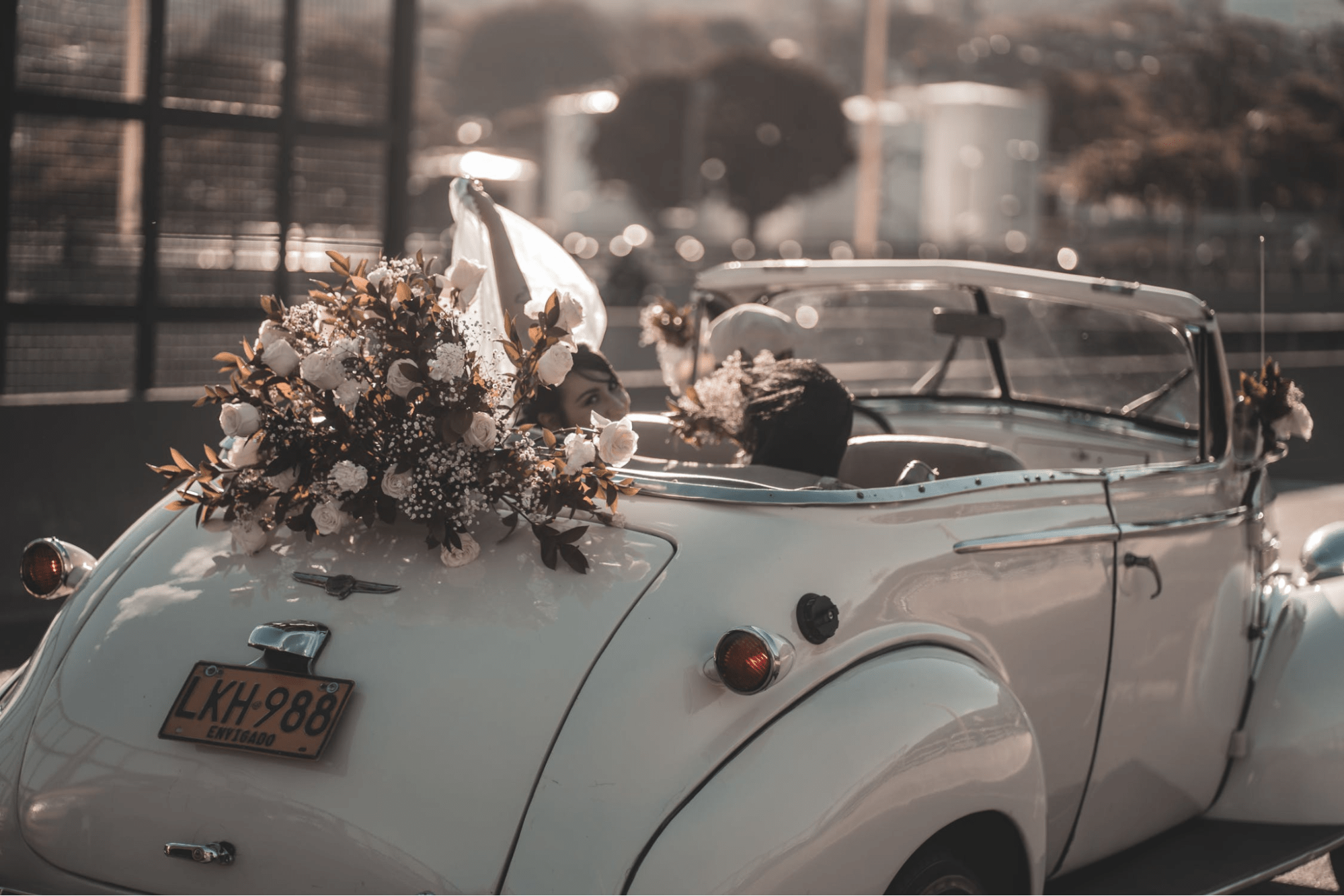 Romantic couple wedding poses in a car