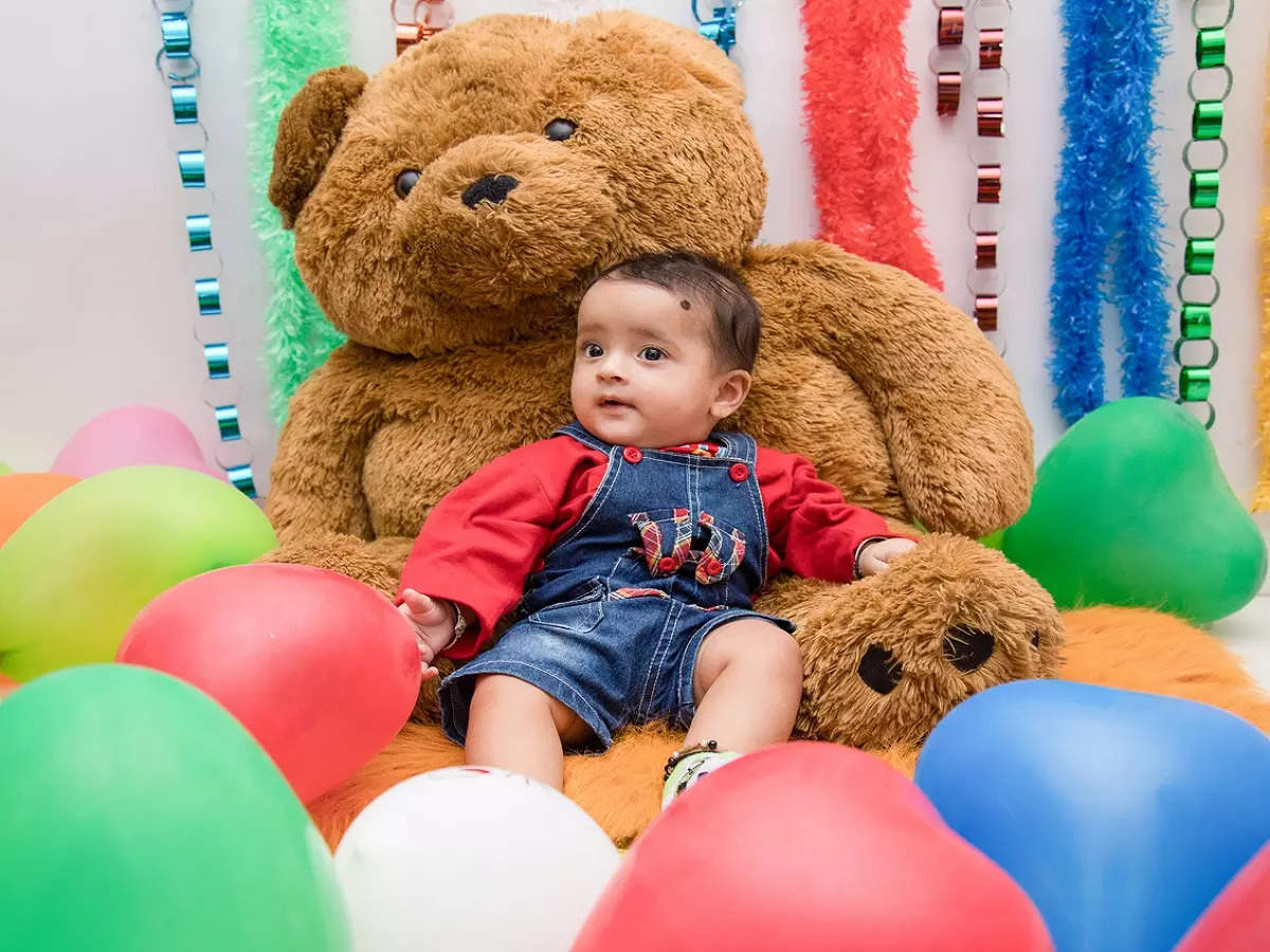 Cute baby with a stuffed teddy toy