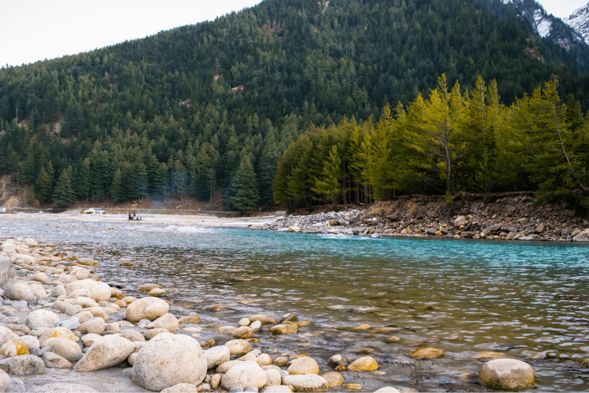 River in Harsil is full of pebbles and stones near the mountains.