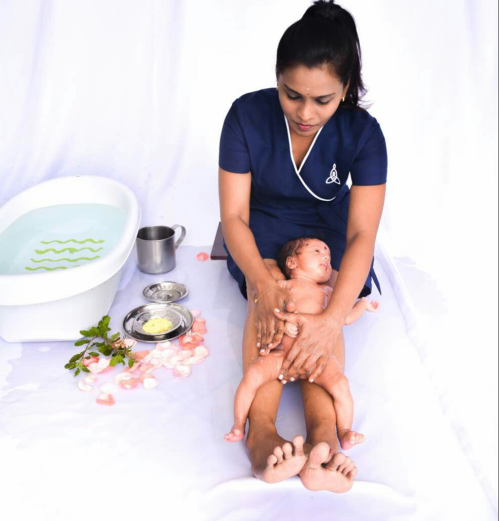  A baby taking bath with its mommy