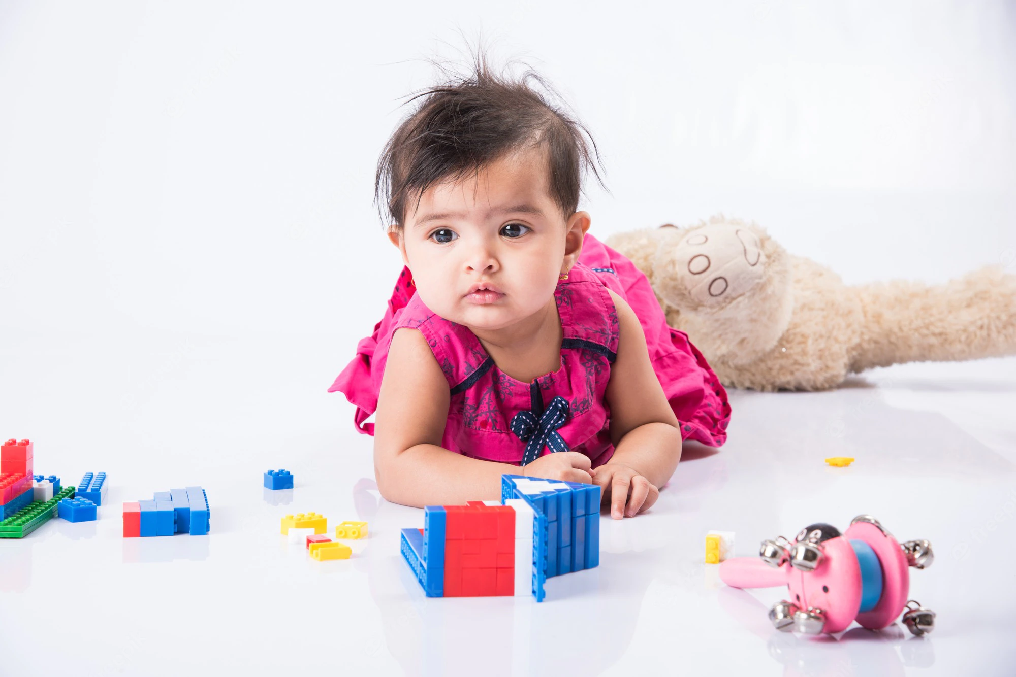  The little girl is playing with her favourite toy blocks.