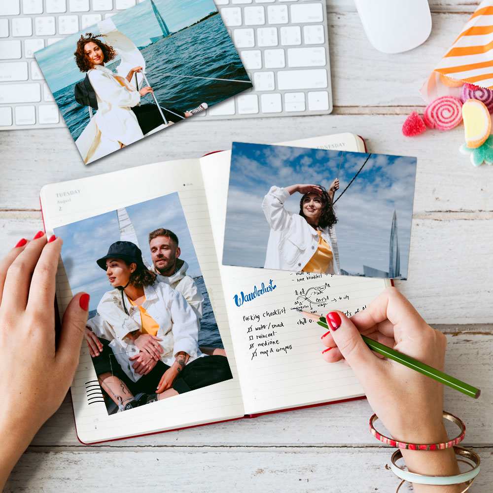 Hand holding Retro Polaroid photos of a couple, with 'Love' and 'Goa 2024' captions, tropical backdrop