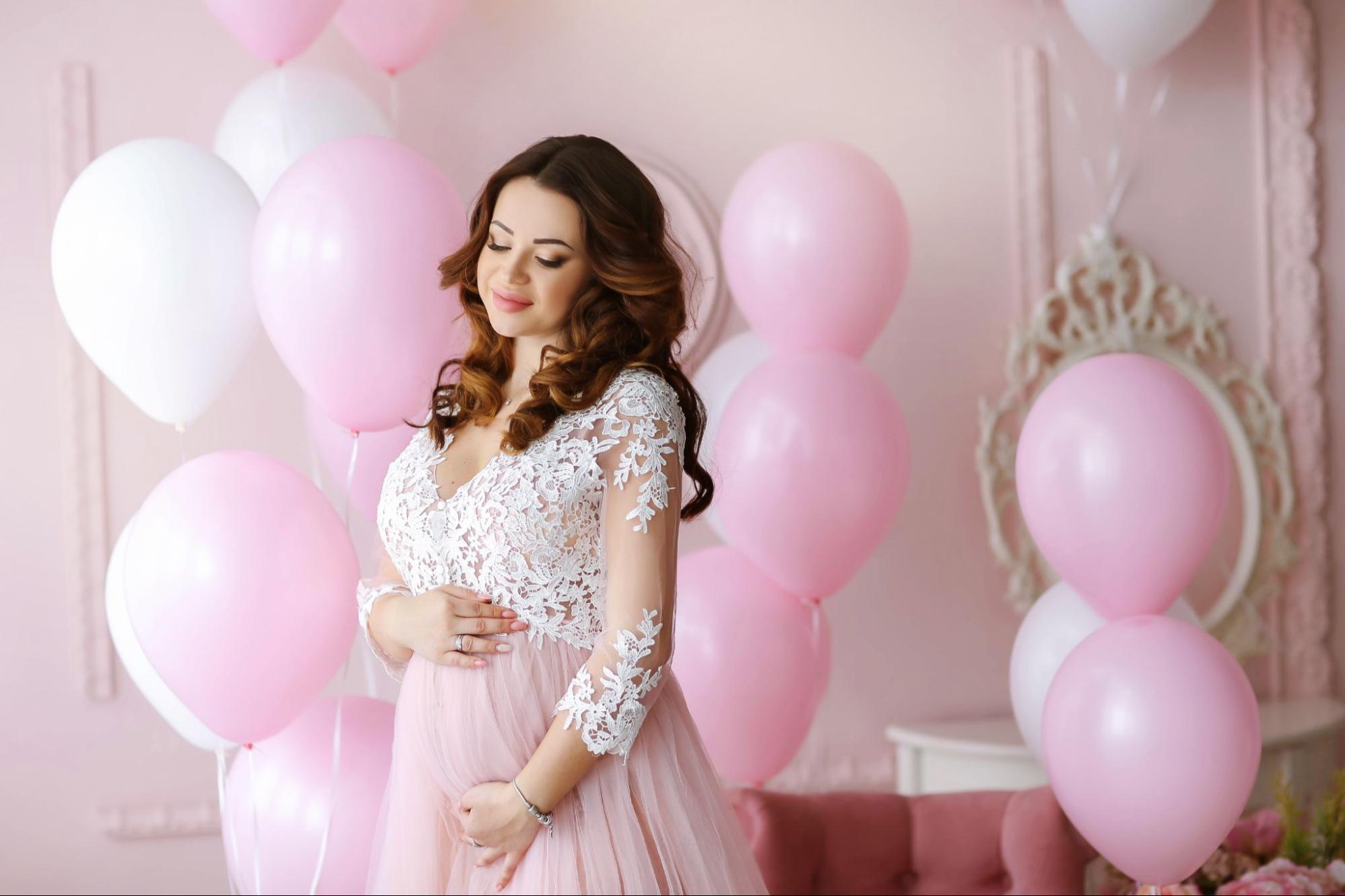 -Floating joy: Balloon pose at baby shower, capturing the whimsy and excitement in the air.