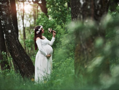 Radiant mom-to-be surrounded by blossoming nature.