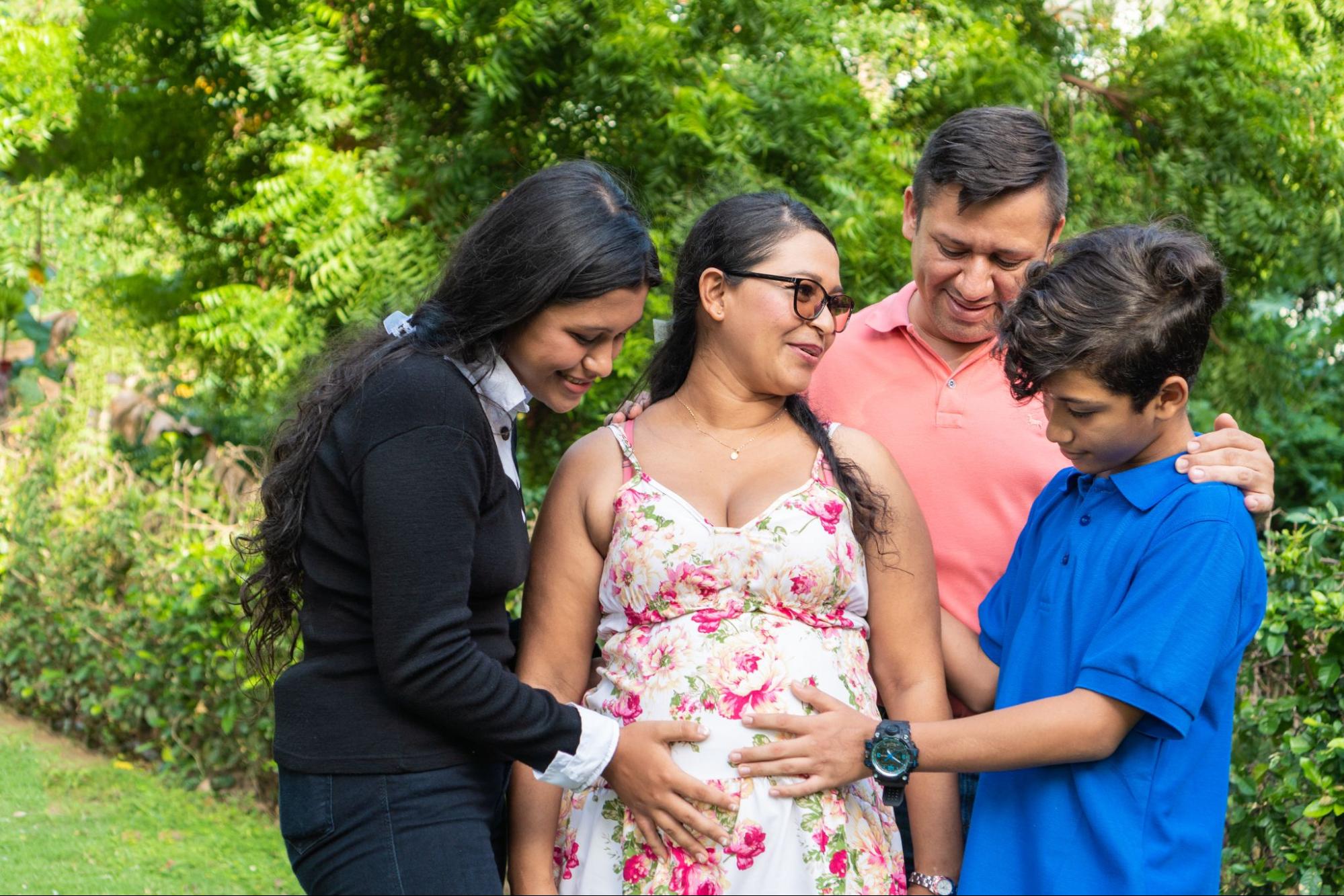 Family pose at baby shower, cherishing the joy of growing our love