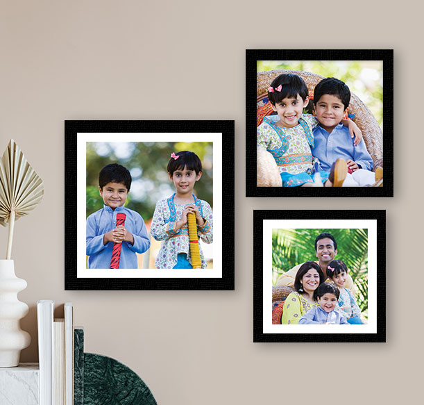 Three framed photos of a loving family, beautifully displayed on a wall