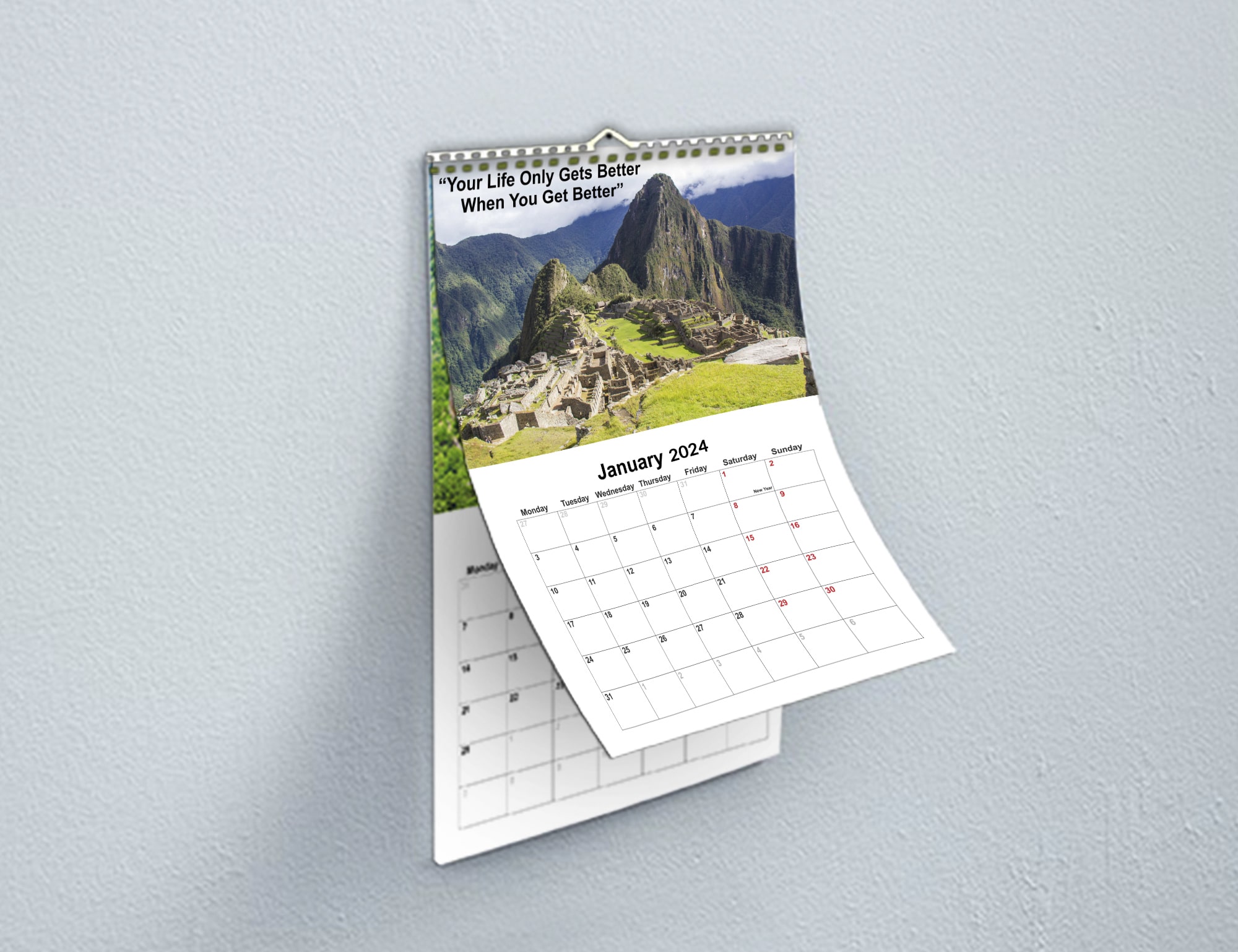 A calendar on a wall with a majestic mountain in the background.