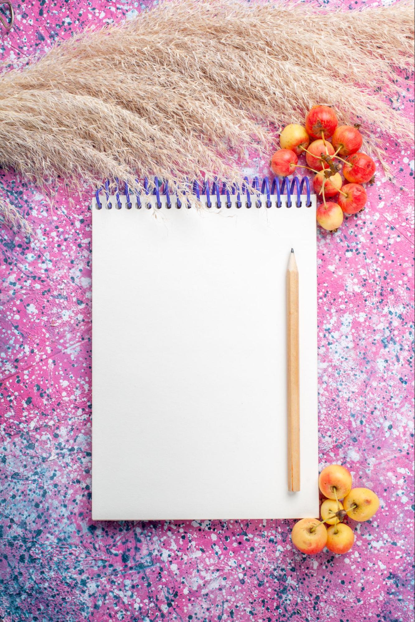 Artistic Notepad and Pencil on Vibrant Background for Birthday Return Gift Ideas.