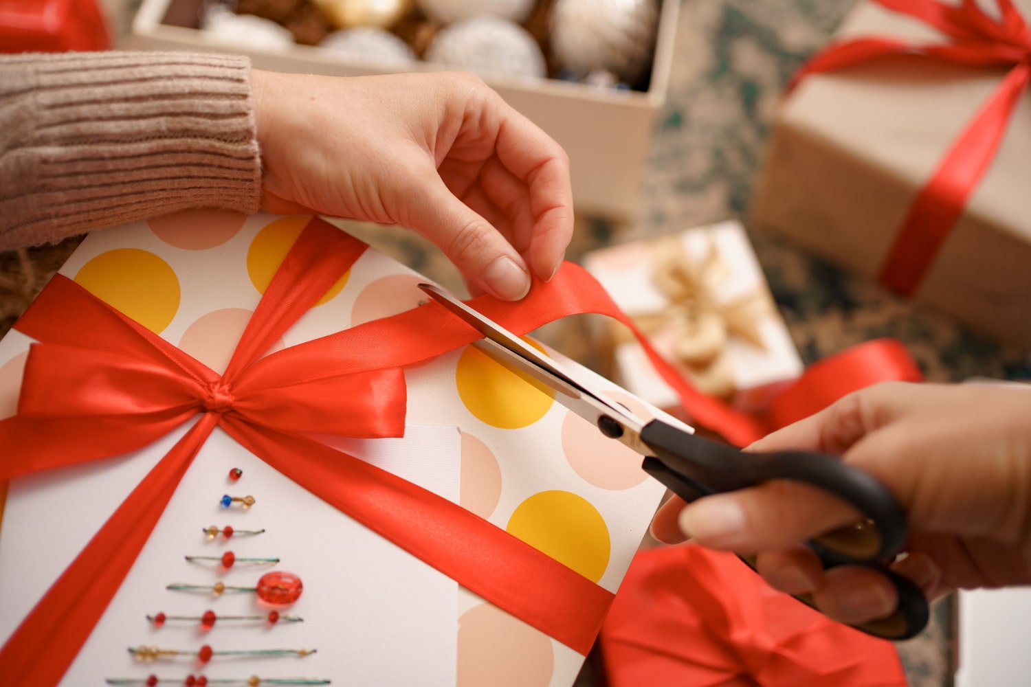 Crafting a unique wedding gift with vibrant wrapping paper and ribbon.