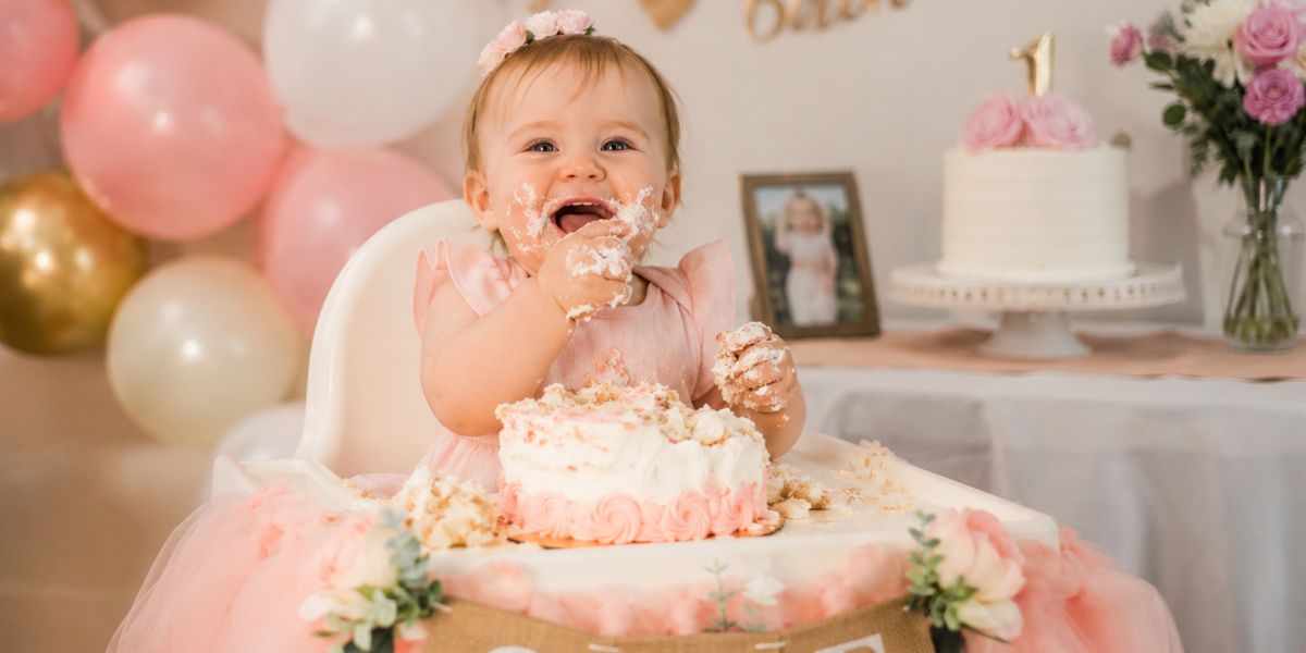 Baby with a smash cake, a popular 1st birthday celebration idea
