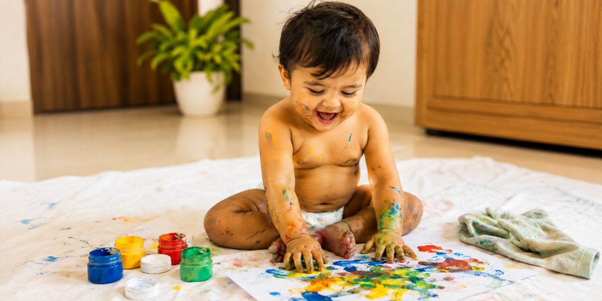 Creative 6 month baby photoshoot prompt with baby-safe paint